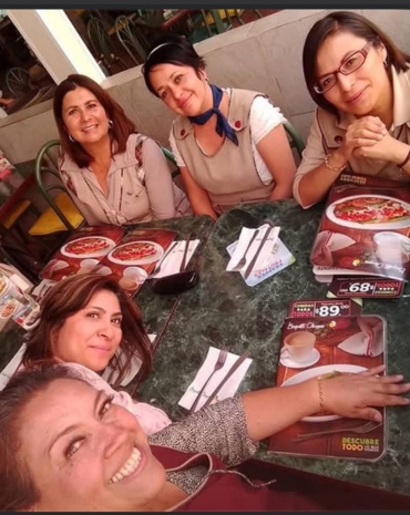 Grupo de amigas compartiendo pan y café en Bisquets Obregón